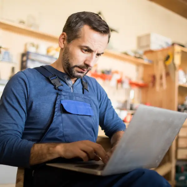 Tradesman checking his online business